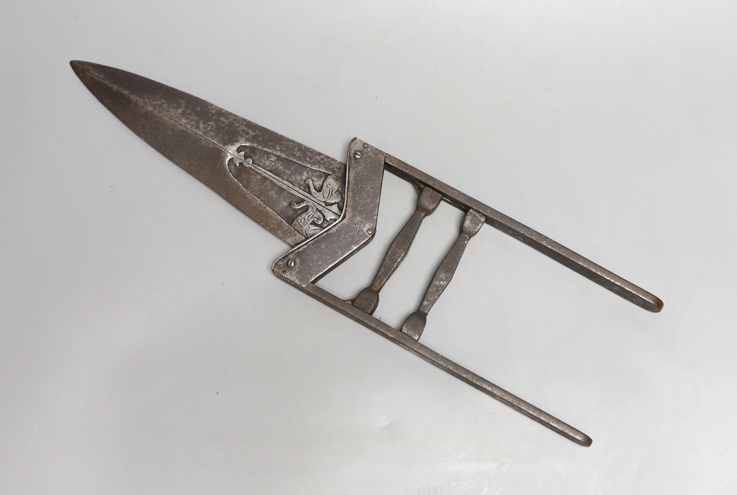 An Indian 19th century ‘scissors katar’, blades chiselled with elephant heads open to reveal an inner blade when grip is squeezed, overall length 40cms